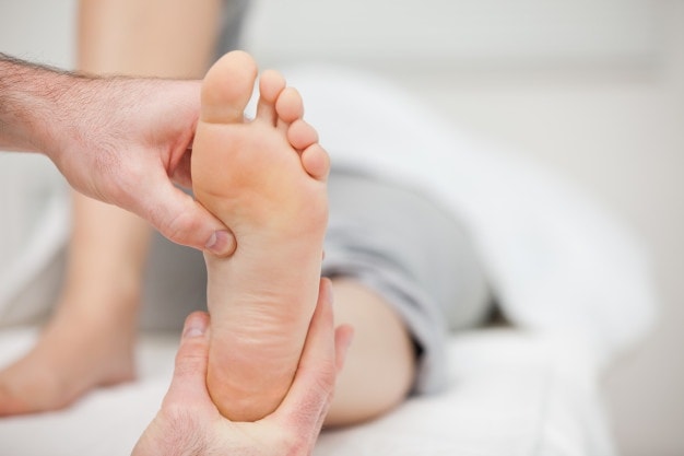 Massage therapist holding a foot