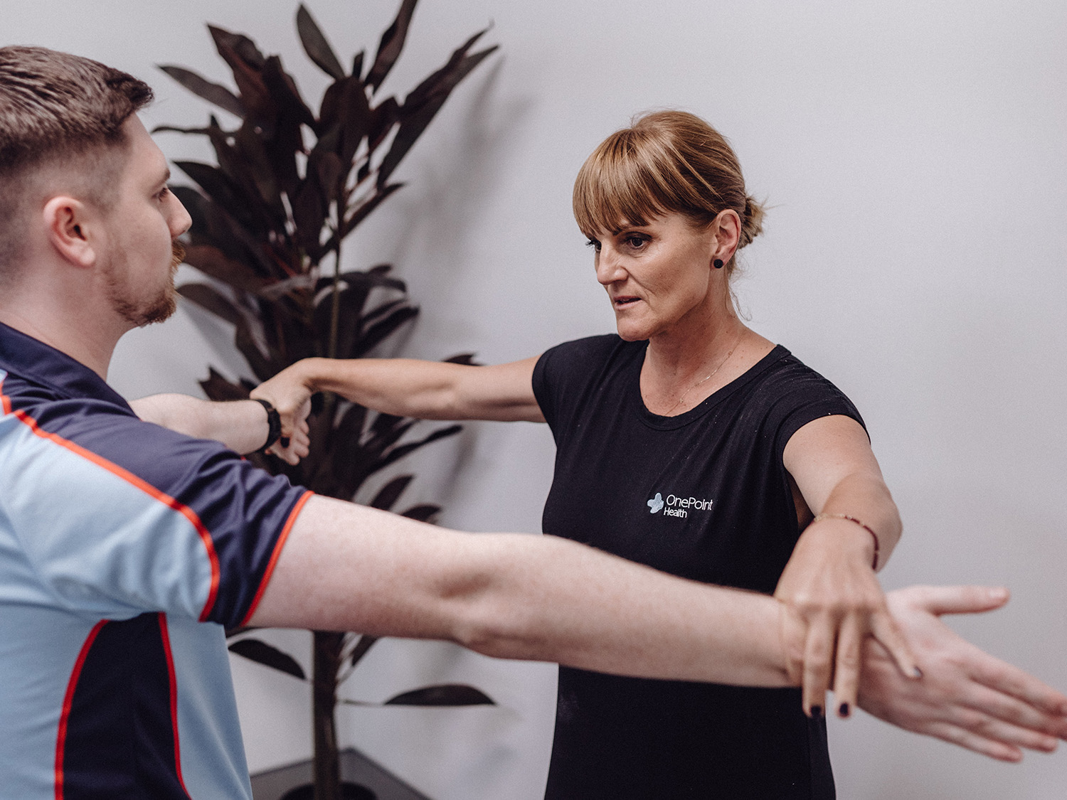 Physiotherapist helping patient with tennis elbow